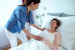 Caregiver reviews a personalized care plan with an older resident at a dining table.