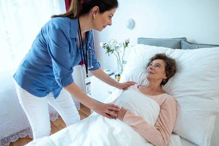 Caregiver reviews a personalized care plan with an older resident at a dining table.